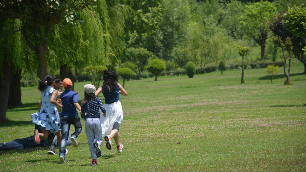 Kids running in the garden at Chashme Shahi Srinagar